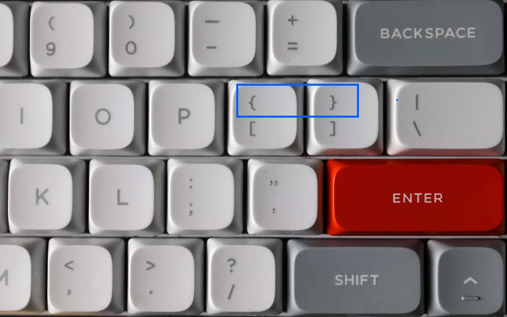 Teclado mostrando cómo poner llave en Word. Localiza las llaves {} en tu teclado para usarlas en tus documentos.